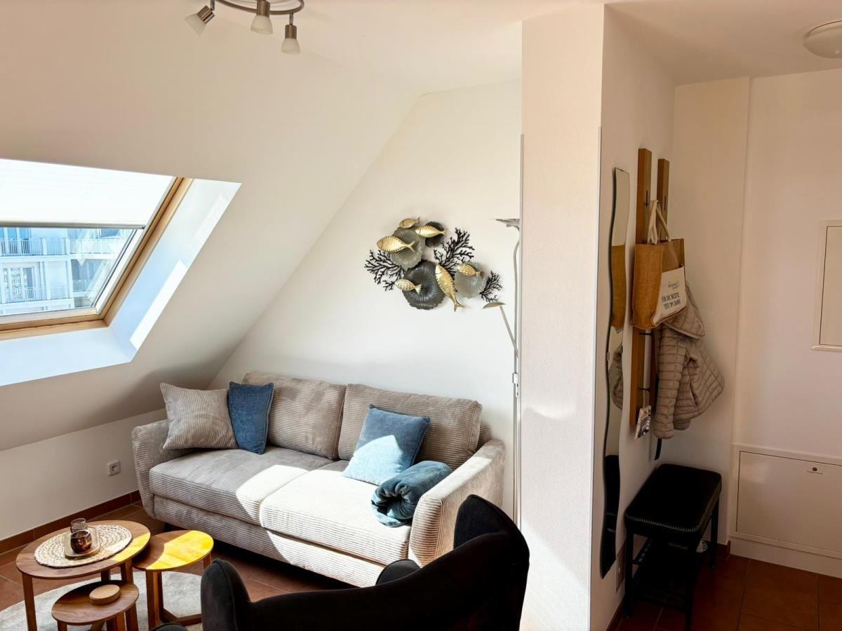 Wohnbereich mit Sofa, Sitzgelegenheit und Dachfenster. Wanddekoration und Hängeregale.