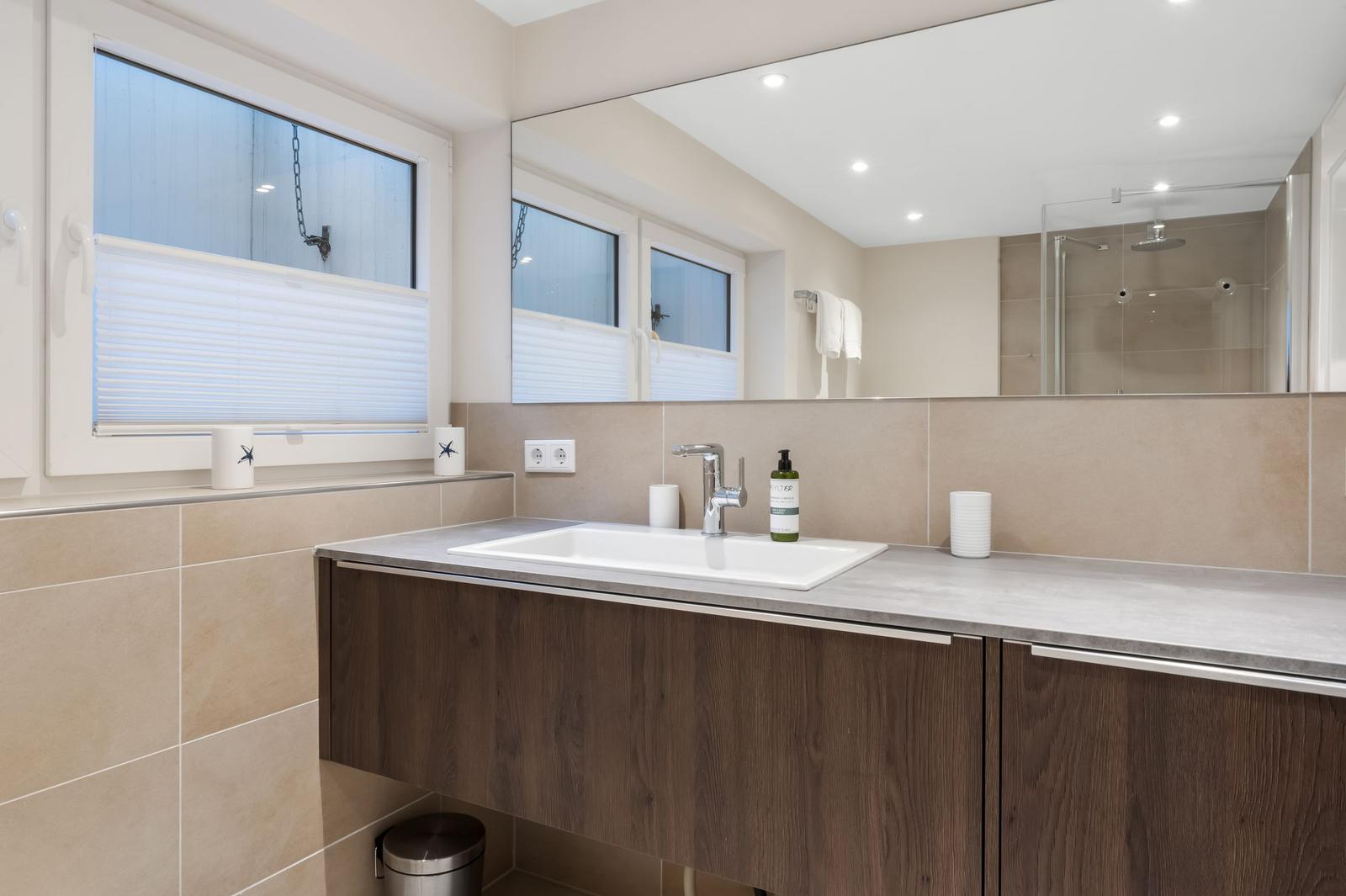 Bathroom with sink, mirror, and shower
