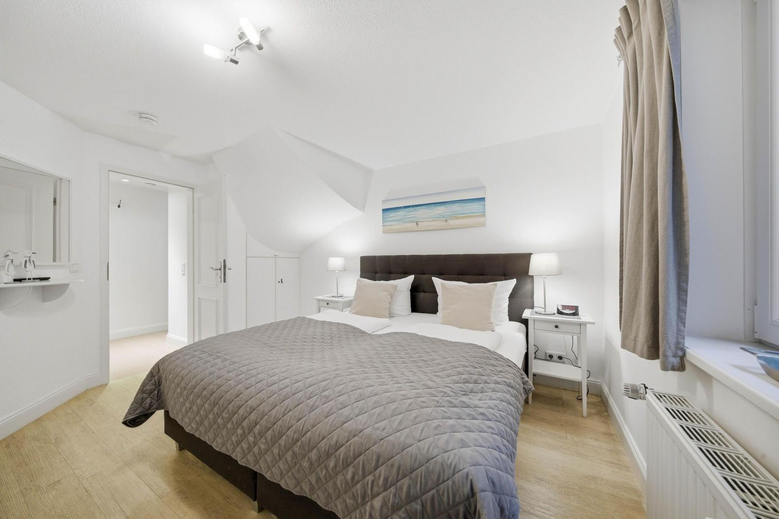 Bedroom with double bed, nightstands, and window