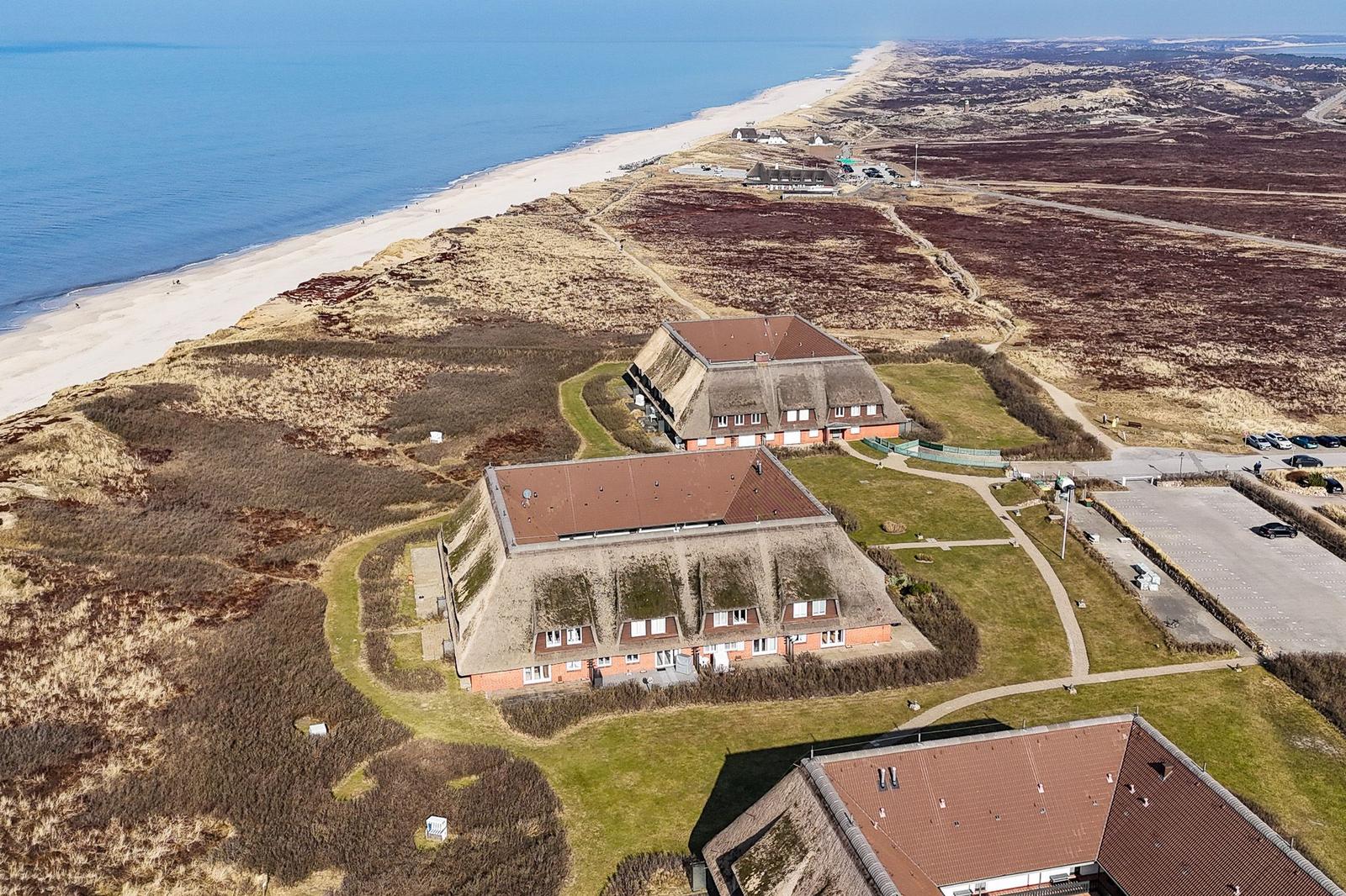 House with green roofs and view of beach and sea