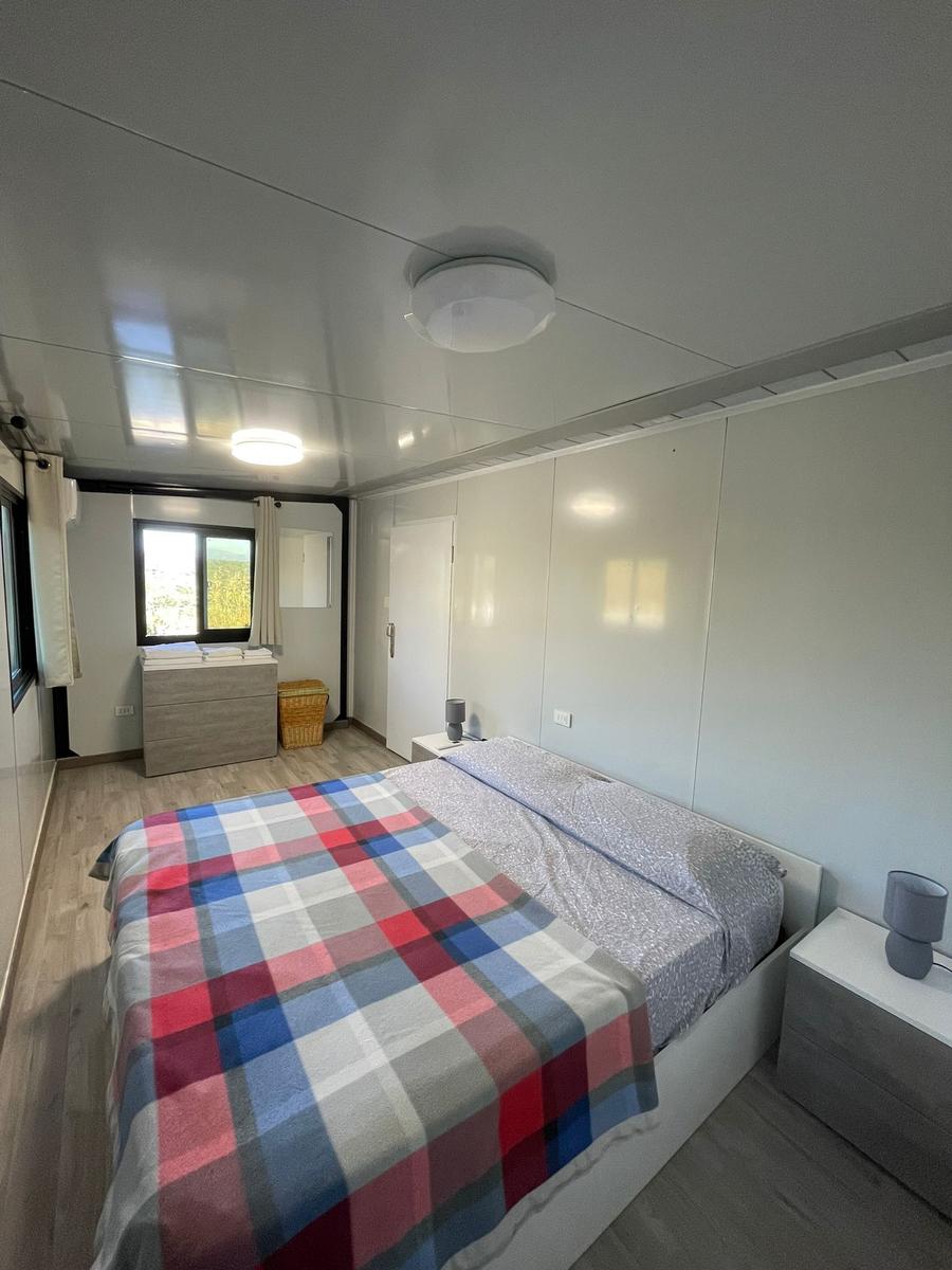 Bedroom with double bed, window, and nightstands.