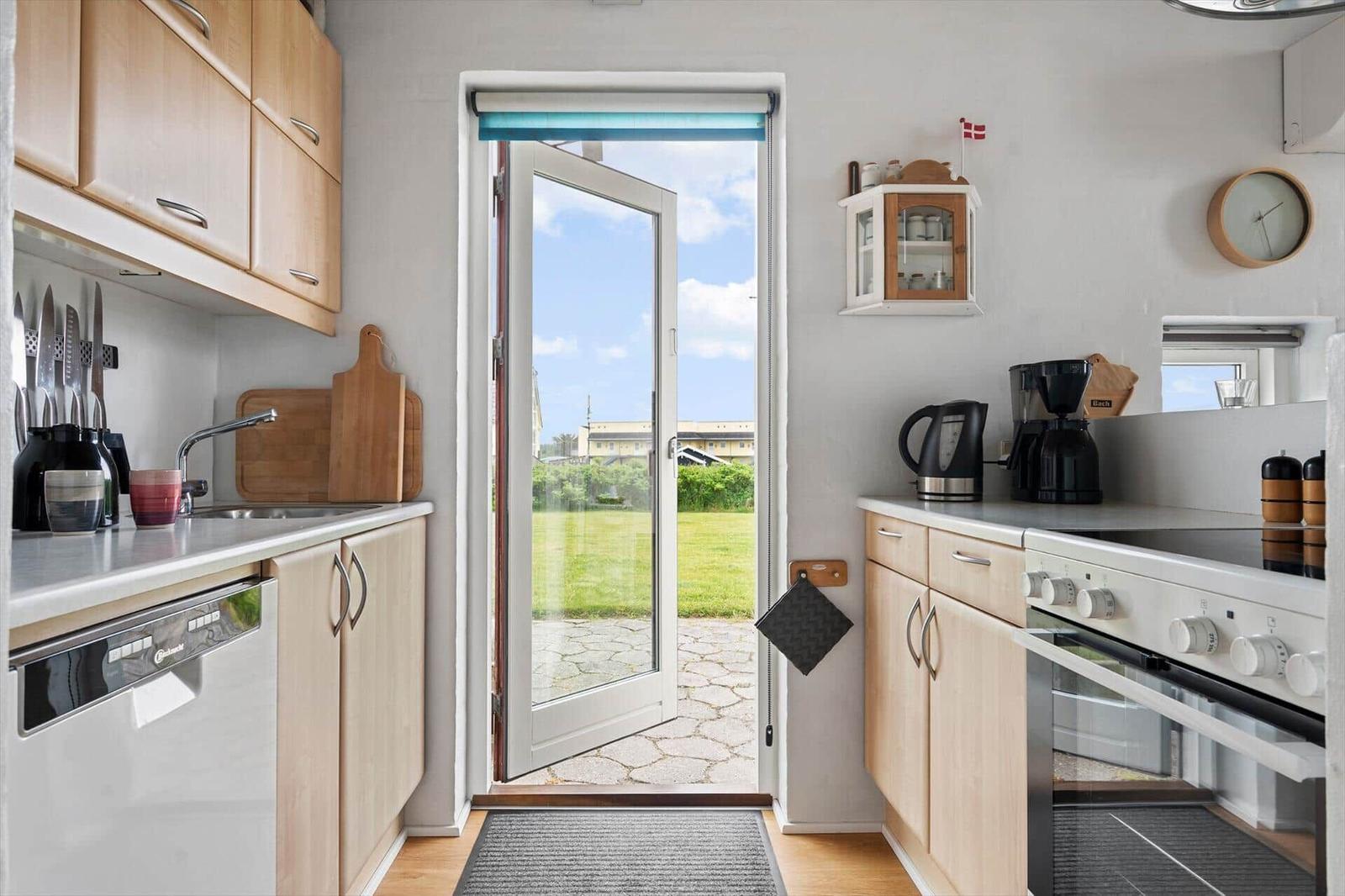 Kitchen with wooden cabinets, sink, and view of garden