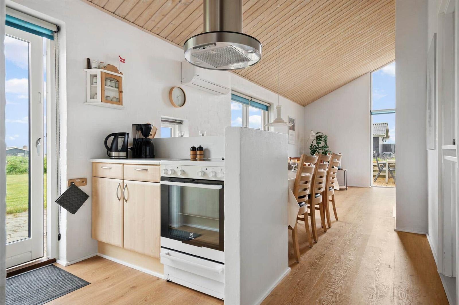 Kitchen with dining area, wooden floor, and wooden ceiling