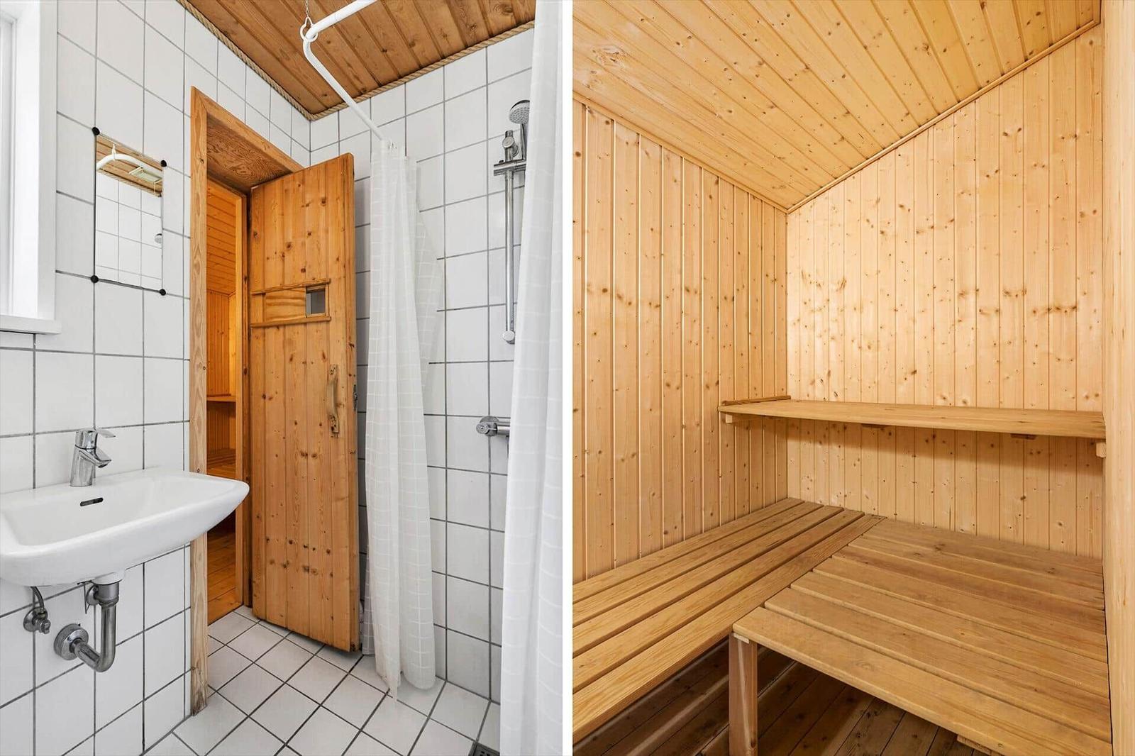 Badezimmer mit Dusche und Waschbecken. Nebenraum ist eine Sauna mit Holzbanken.
