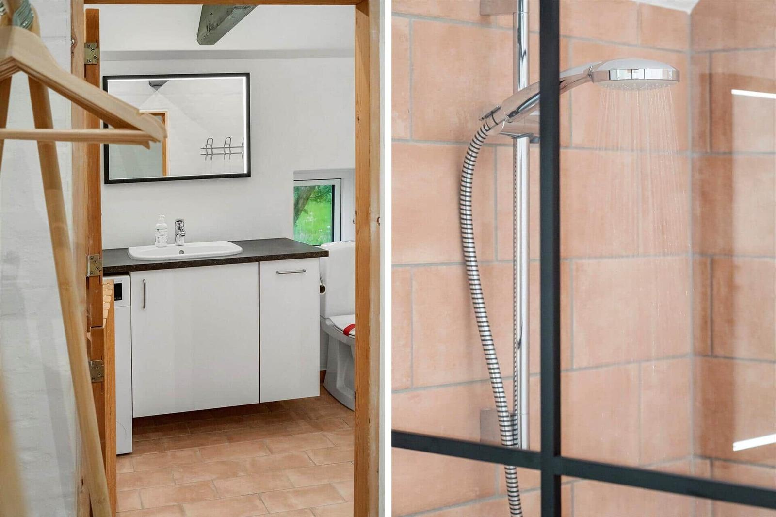 Bathroom with shower and sink. Shower with rain showerhead and terracotta wall tiles.