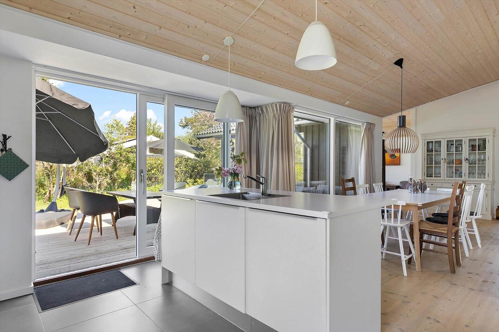 Kitchen with dining area and view of the terrace with garden.