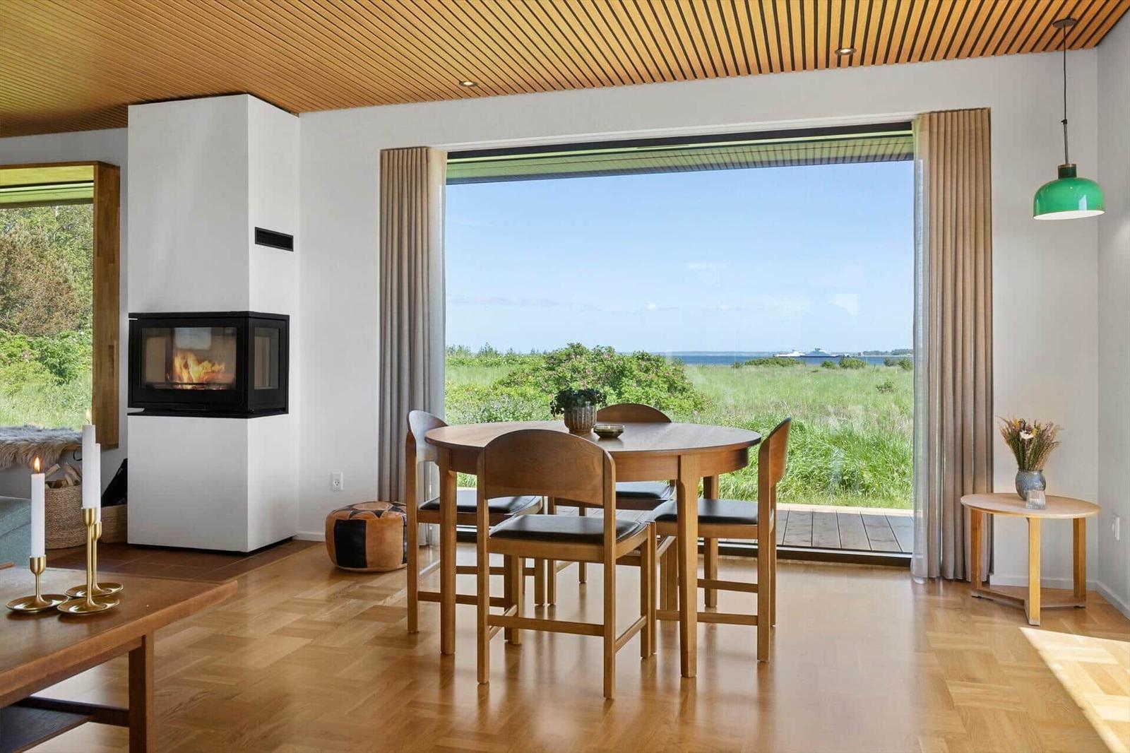 Dining area with view of the landscape and a fireplace.