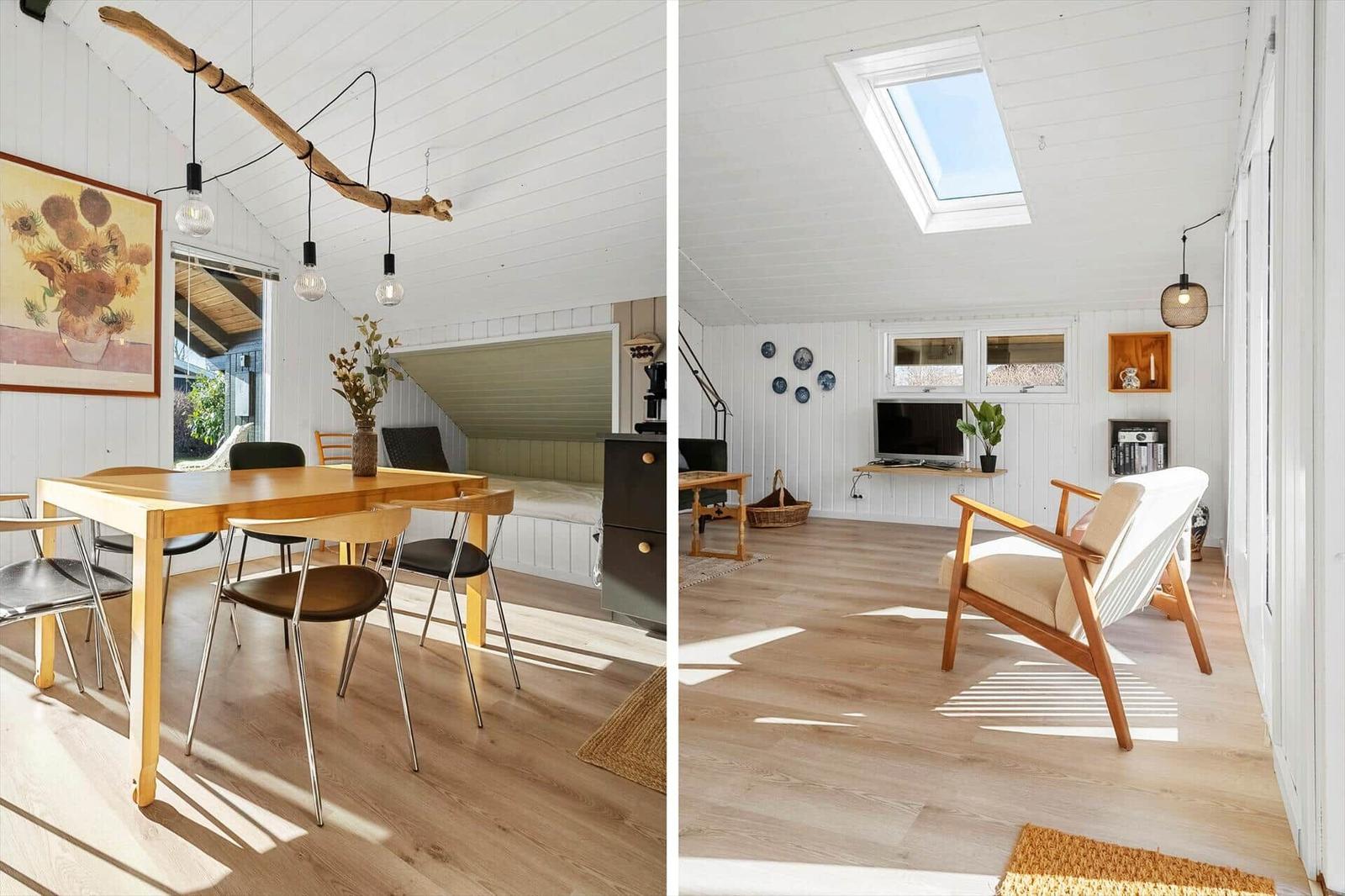Essbereich mit Tisch und Stühlen, Schlafplatz unter Dachschräge, Wohnbereich mit Sessel und Dachfenster.