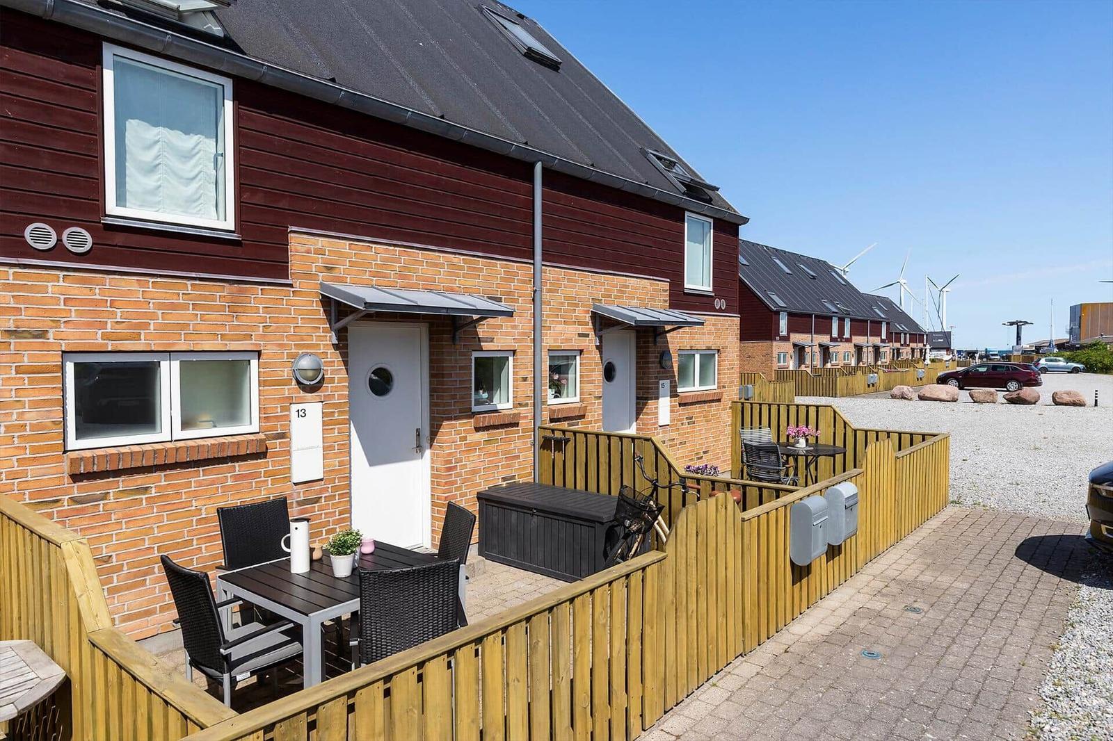 House with terrace, garden furniture, and view of wind turbines.