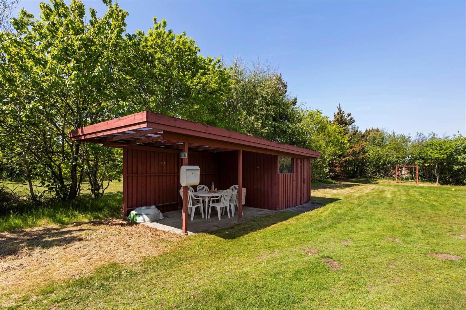 Roter Holzausflugshaus mit Sitzplatz und Grillplatz im Garten