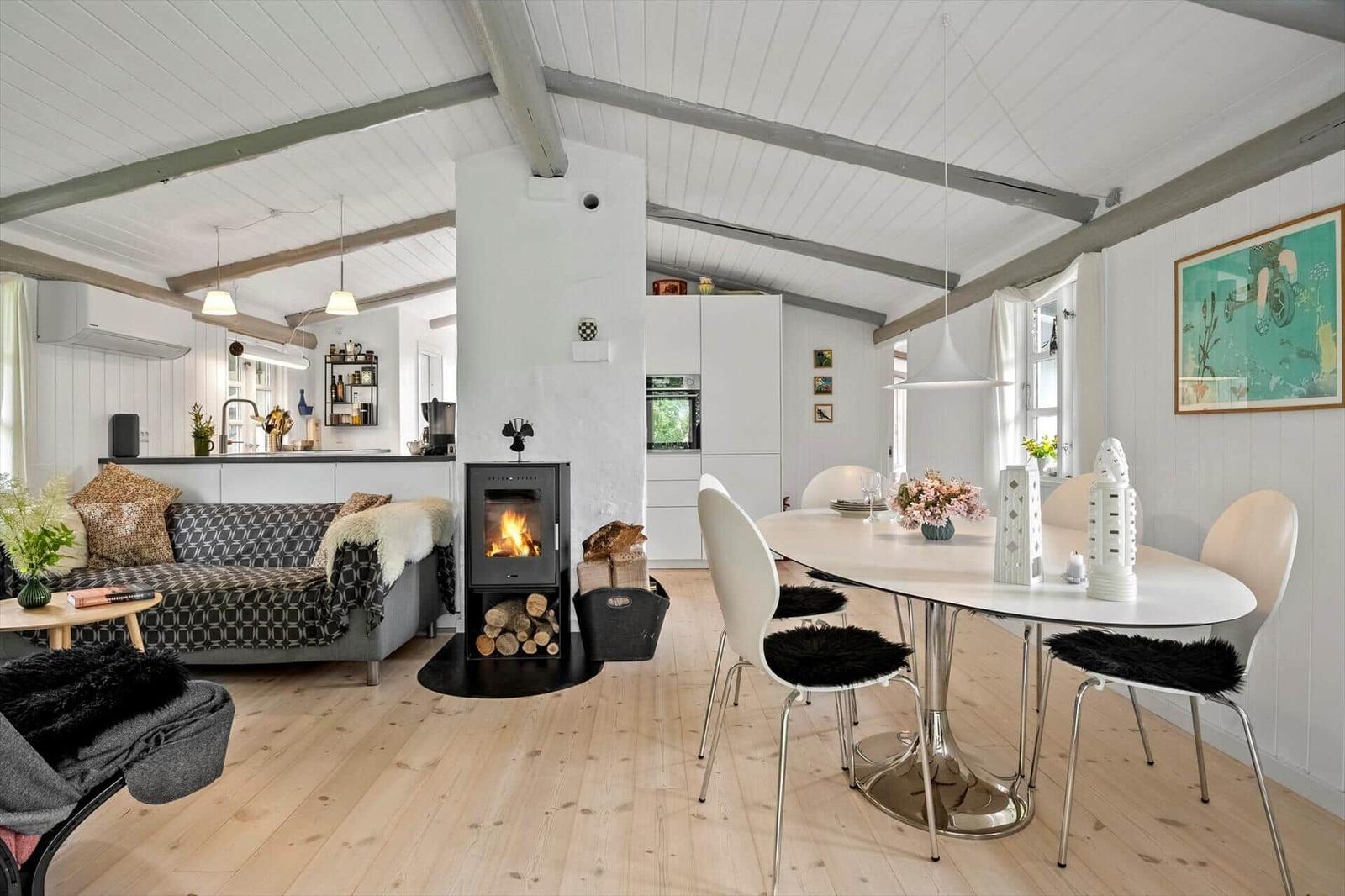 Living area with dining table, fireplace, and kitchenette.