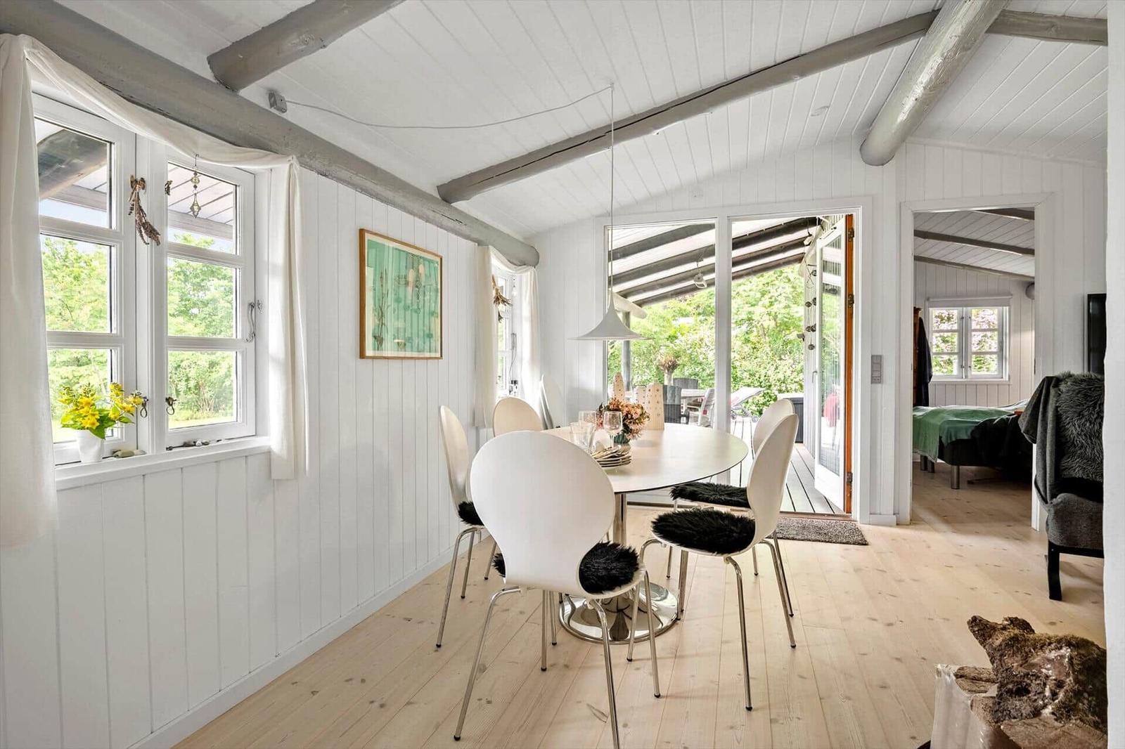 Dining room with table, chairs, and view of terrace