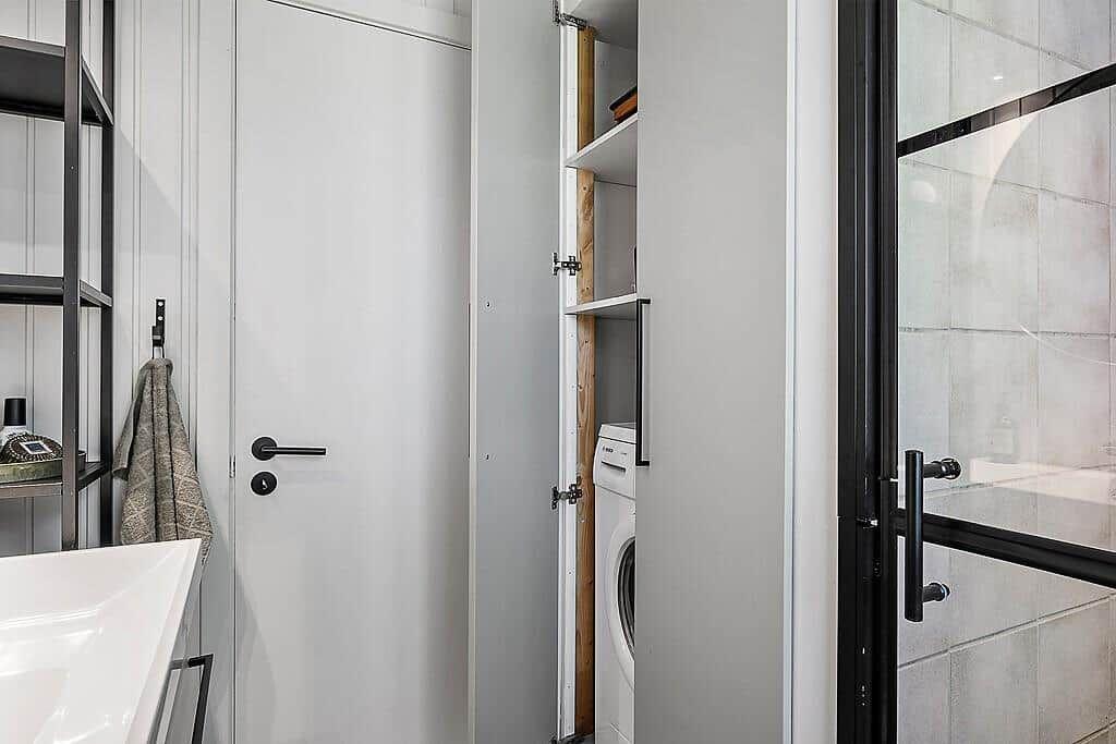 Bathroom with washing machine and shower cabin