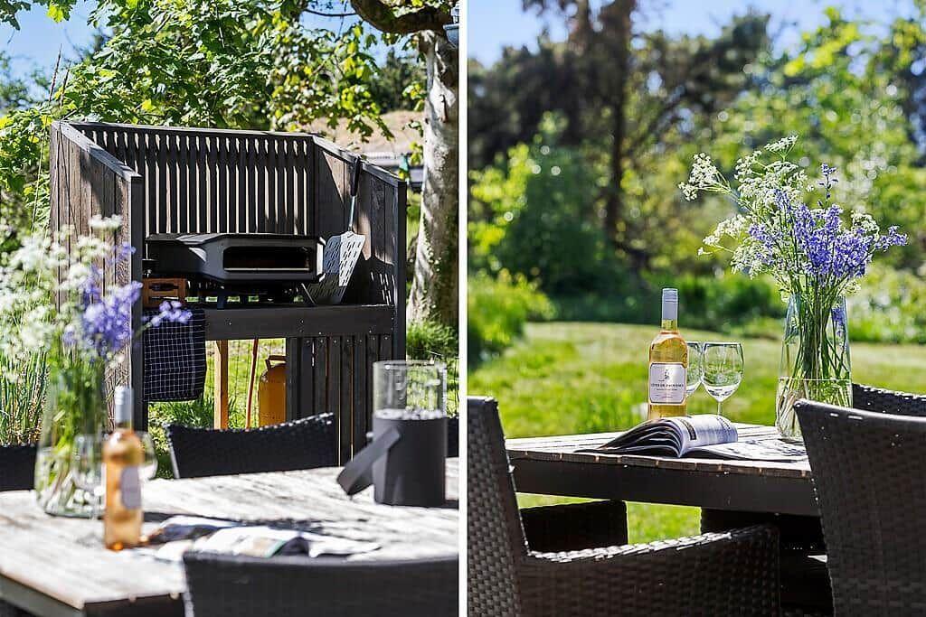 Outdoor area with grill, table, chairs, and flower arrangement.