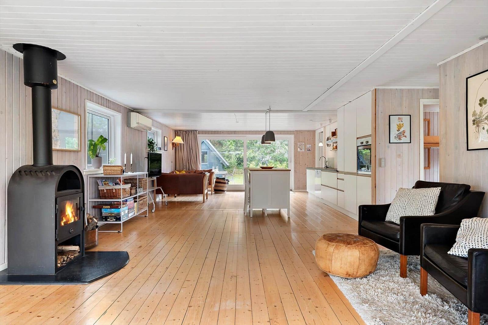 Living area with fireplace, kitchenette, and seating.