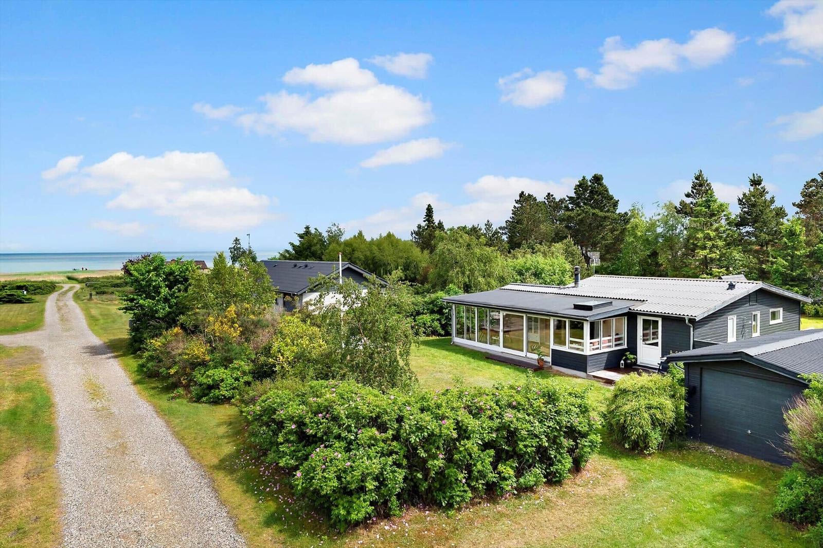 Modern house with large garden and view of the coast.
