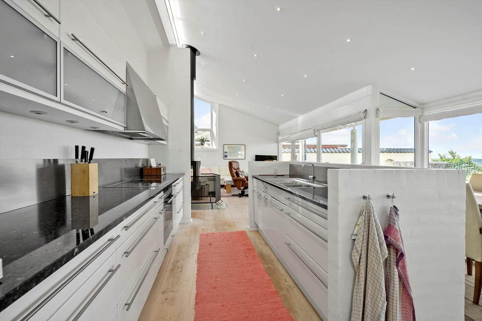 Modern kitchen with view to living area and terrace.