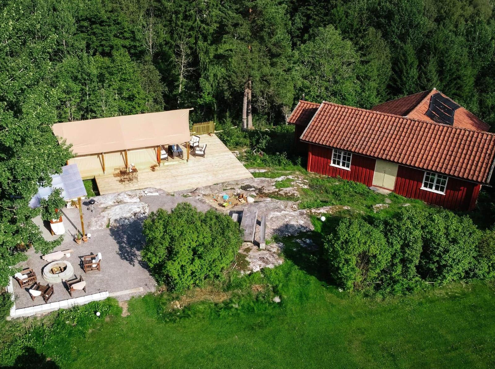 Rotes Haus mit Terrasse und Grillplatz im Wald