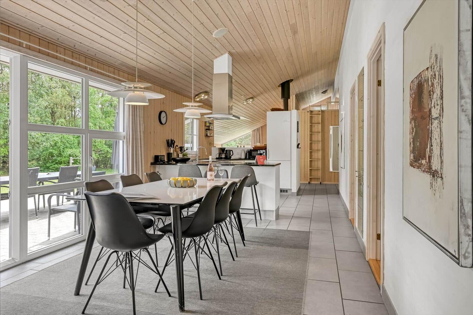 Moderne Küche mit Essbereich und großem Fenster zur Terrasse