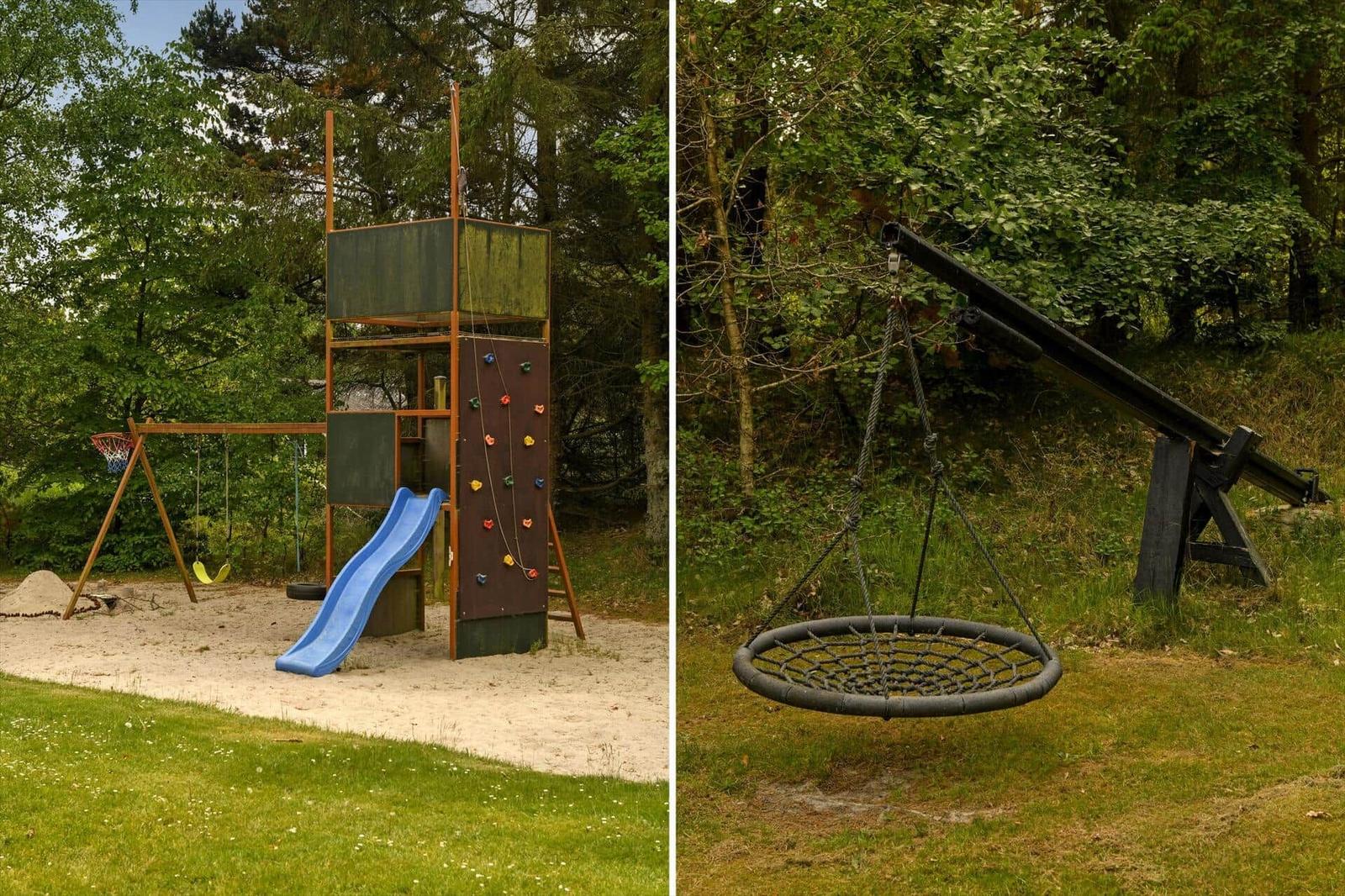 Kinderspielplatz mit Rutsche, Kletterwand und Schaukel im Wald