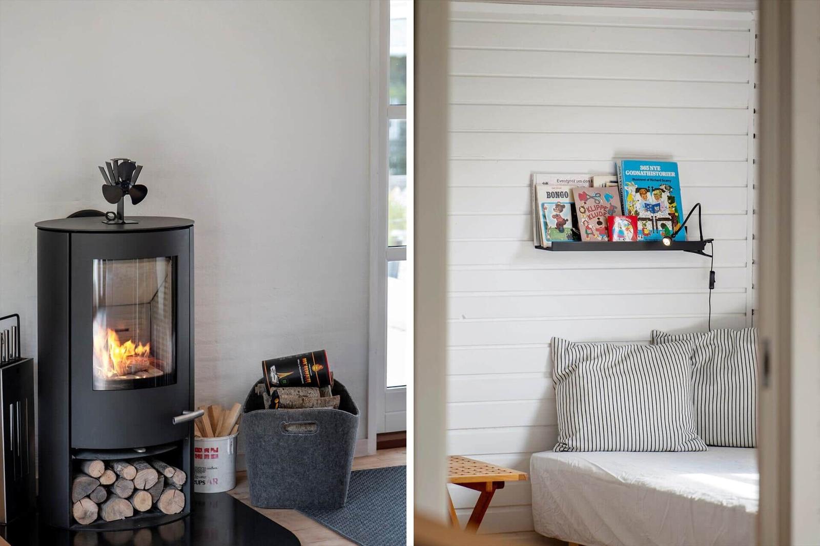 Kamin mit Brennholz und Bücherregal mit Kinderbüchern an der Wand.