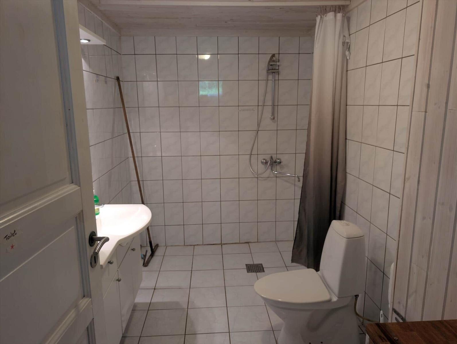 Bathroom with shower, toilet, and sink.