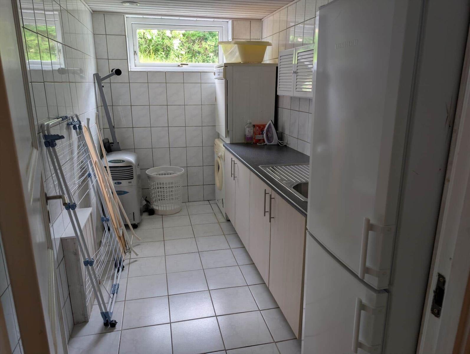 Kitchen with refrigerator, washing machine, and window