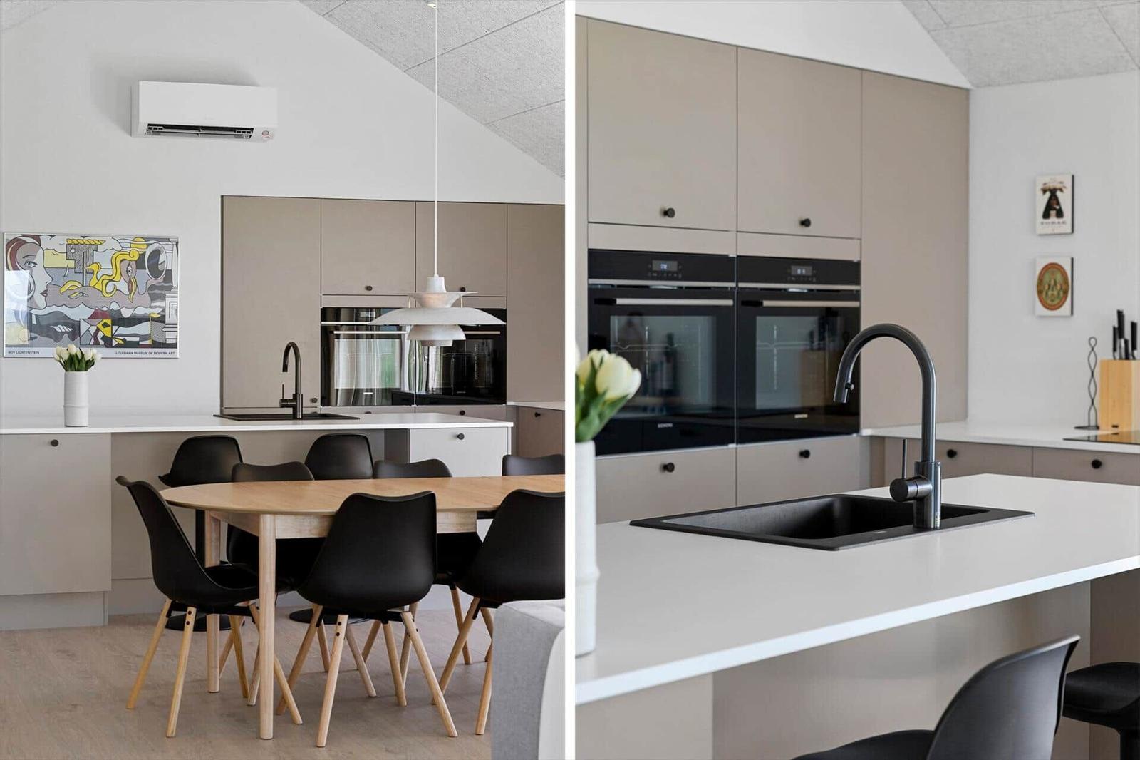 Modern kitchen with dining area, built-in oven, and black faucet.