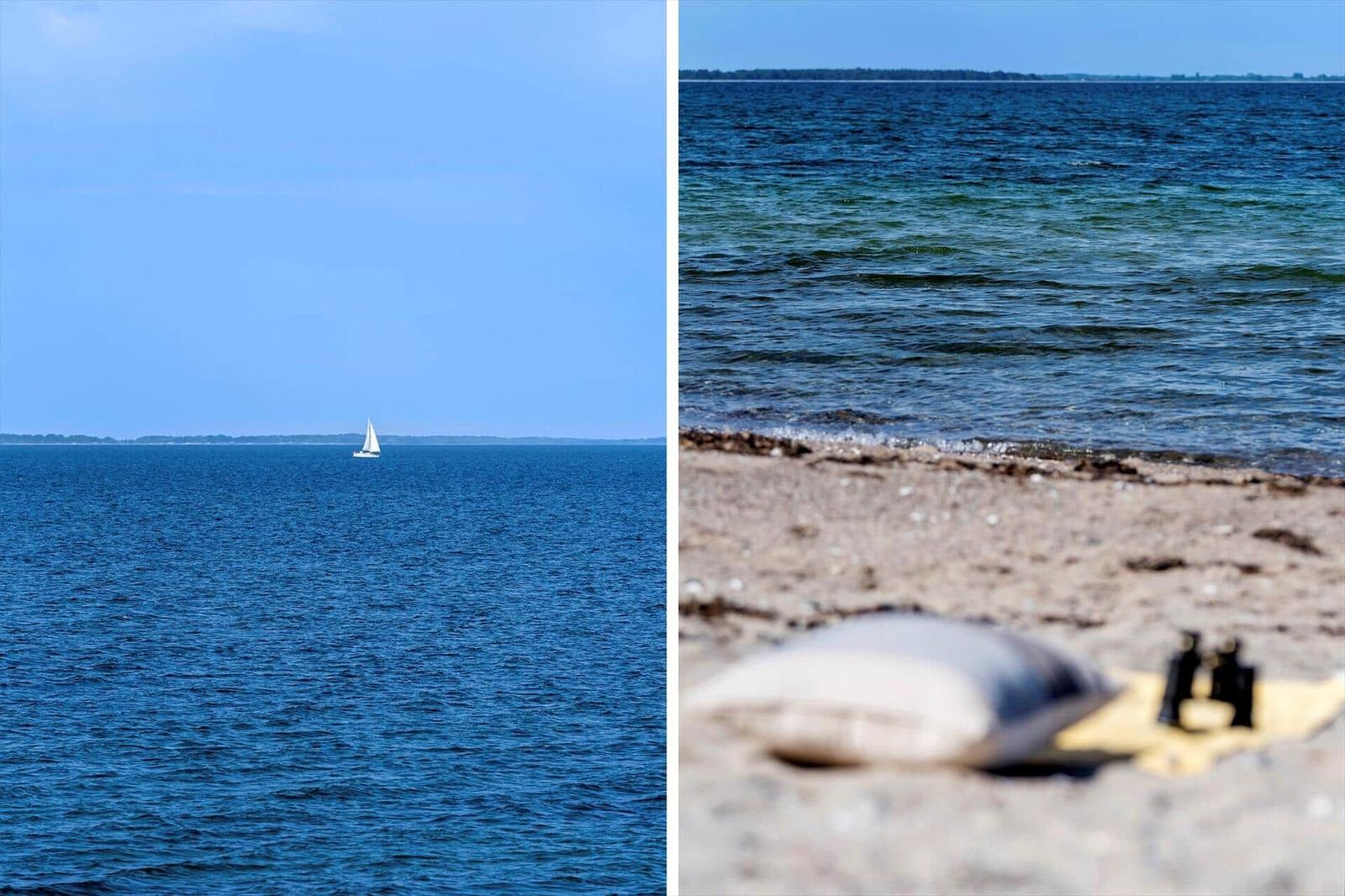 Sailboat on water and beach with cushion and binoculars.