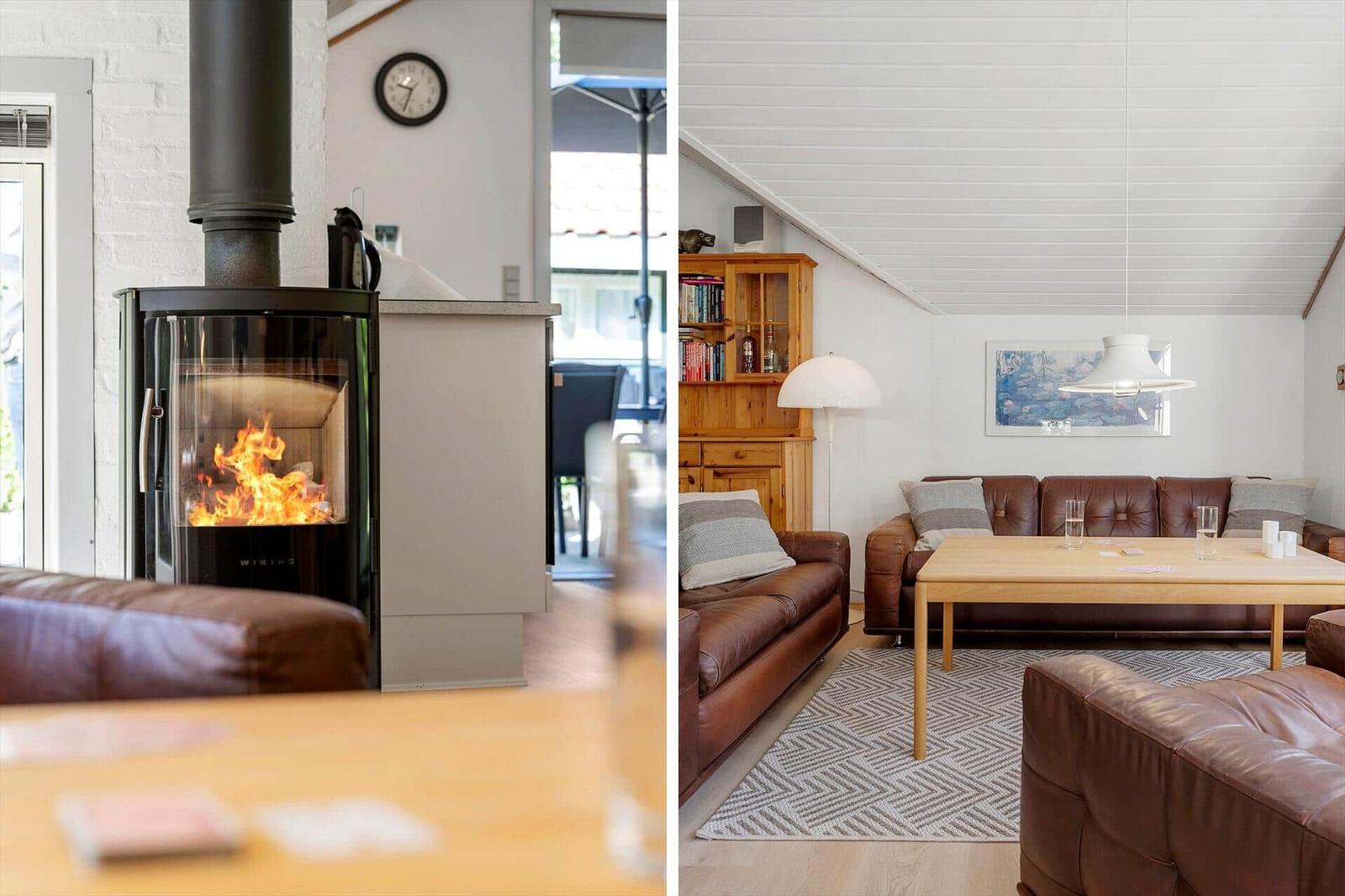 Living room with wooden sofa, table, and wood stove. Light walls and wooden floor.