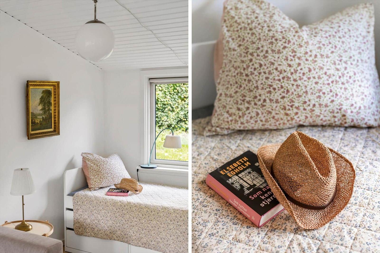 Bedroom with window, bed, and wall picture. Hat and book on bed.