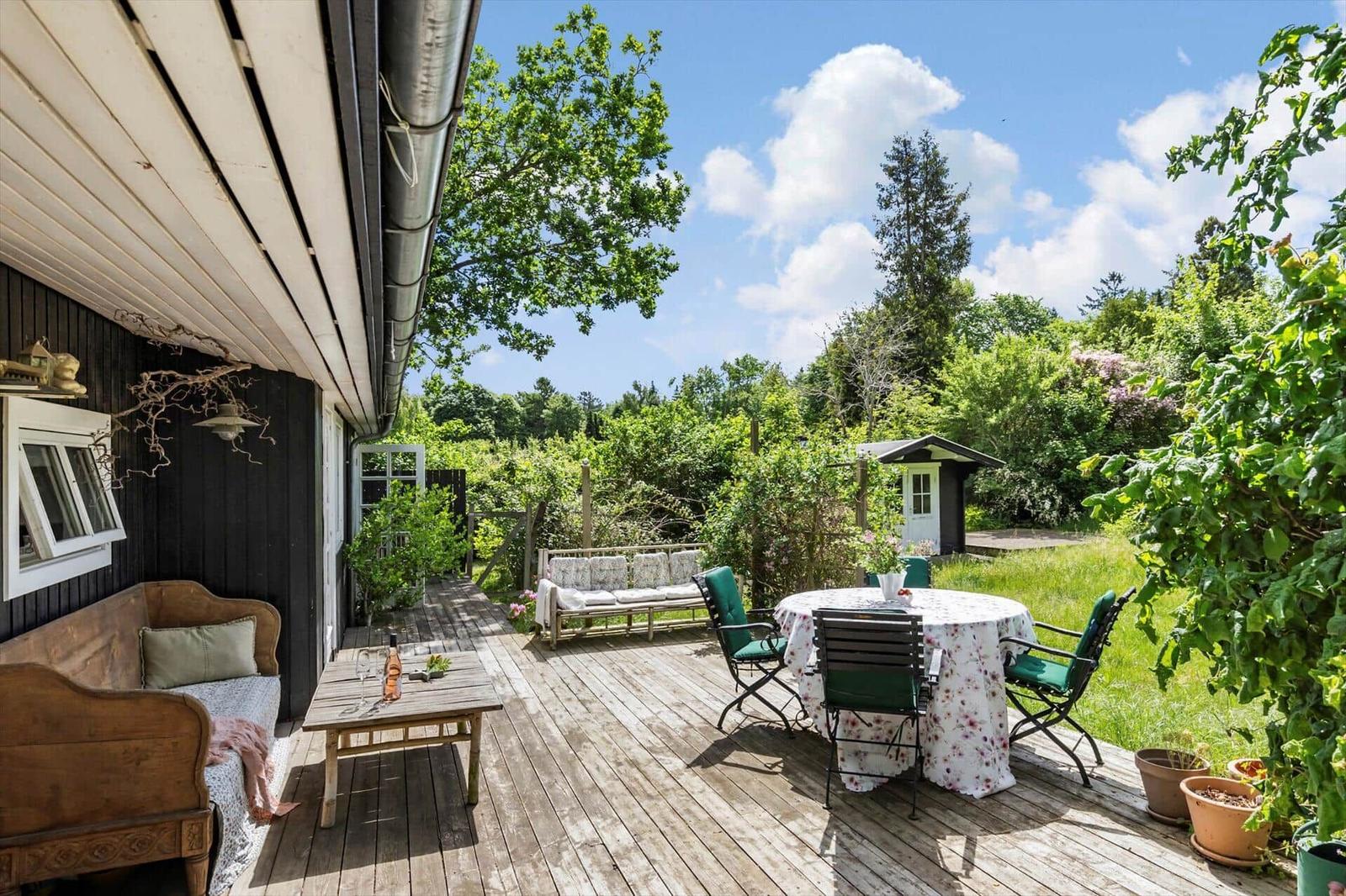 Deck with seating and view of green garden