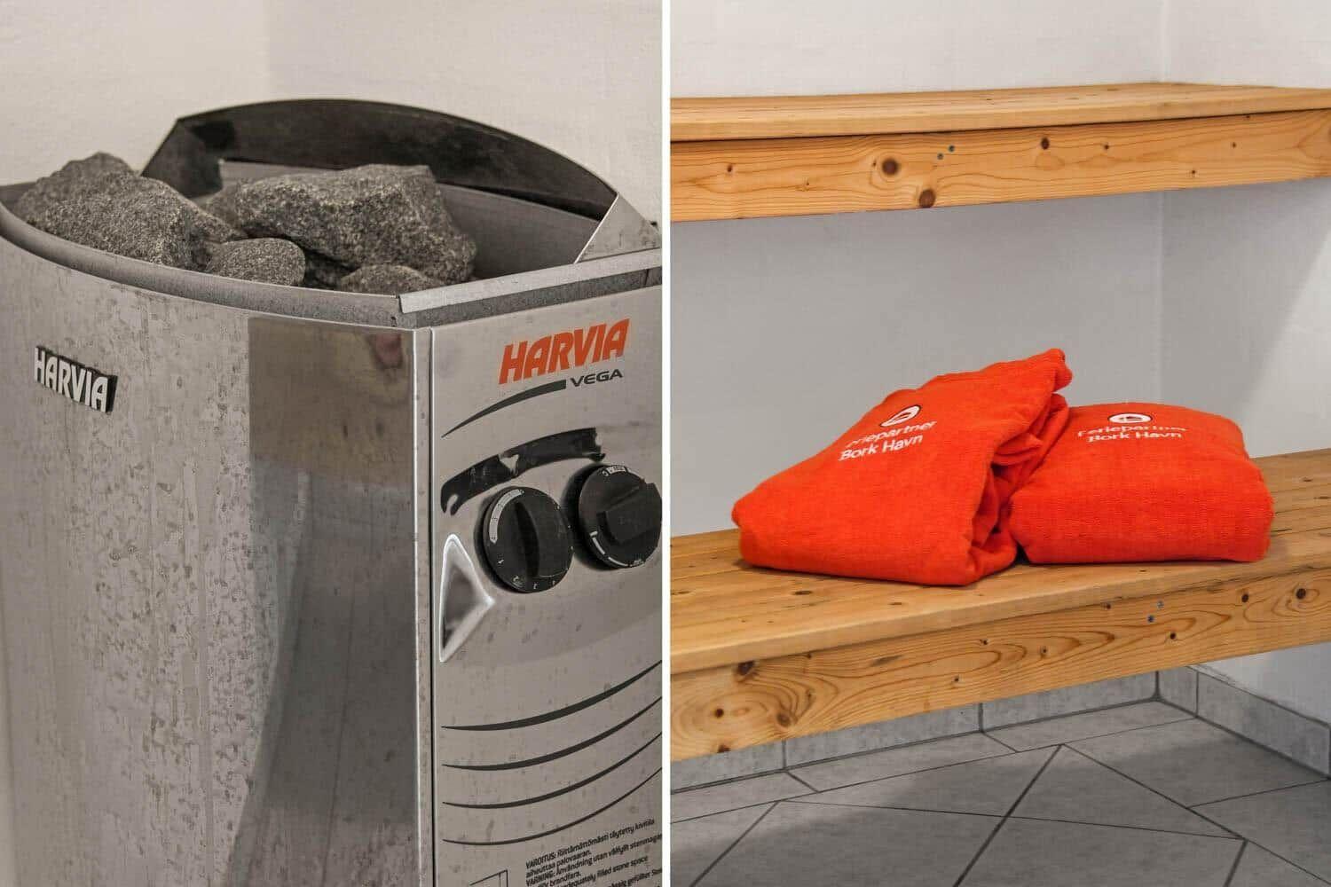 Harvia Sauna mit Steinen und Holzbank mit orangefarbenen Handtüchern.