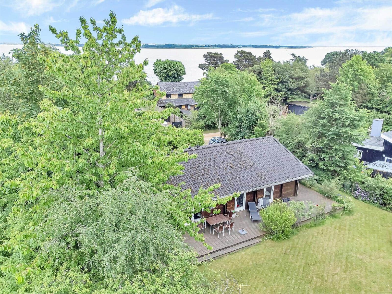 House with terrace, garden, and view of water