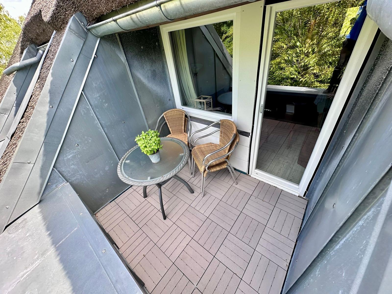 sonniger Balkon im Reetdach