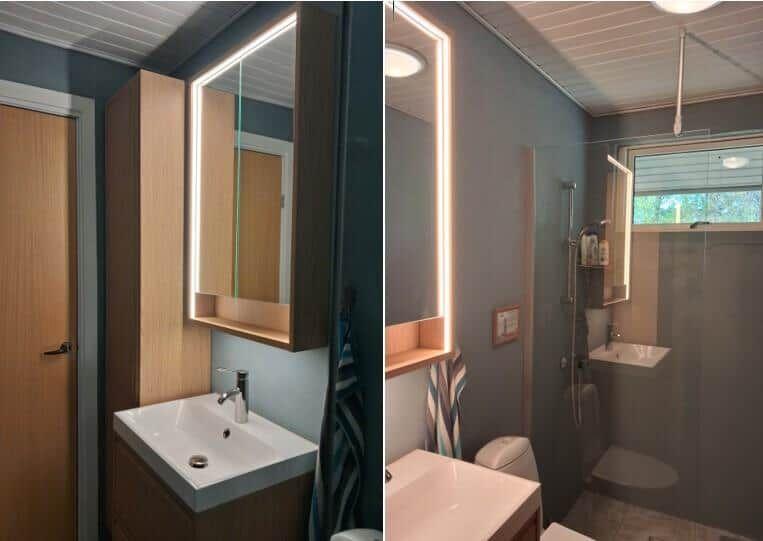 Badezimmer mit beleuchtetem Spiegel, Waschbecken und Dusche.