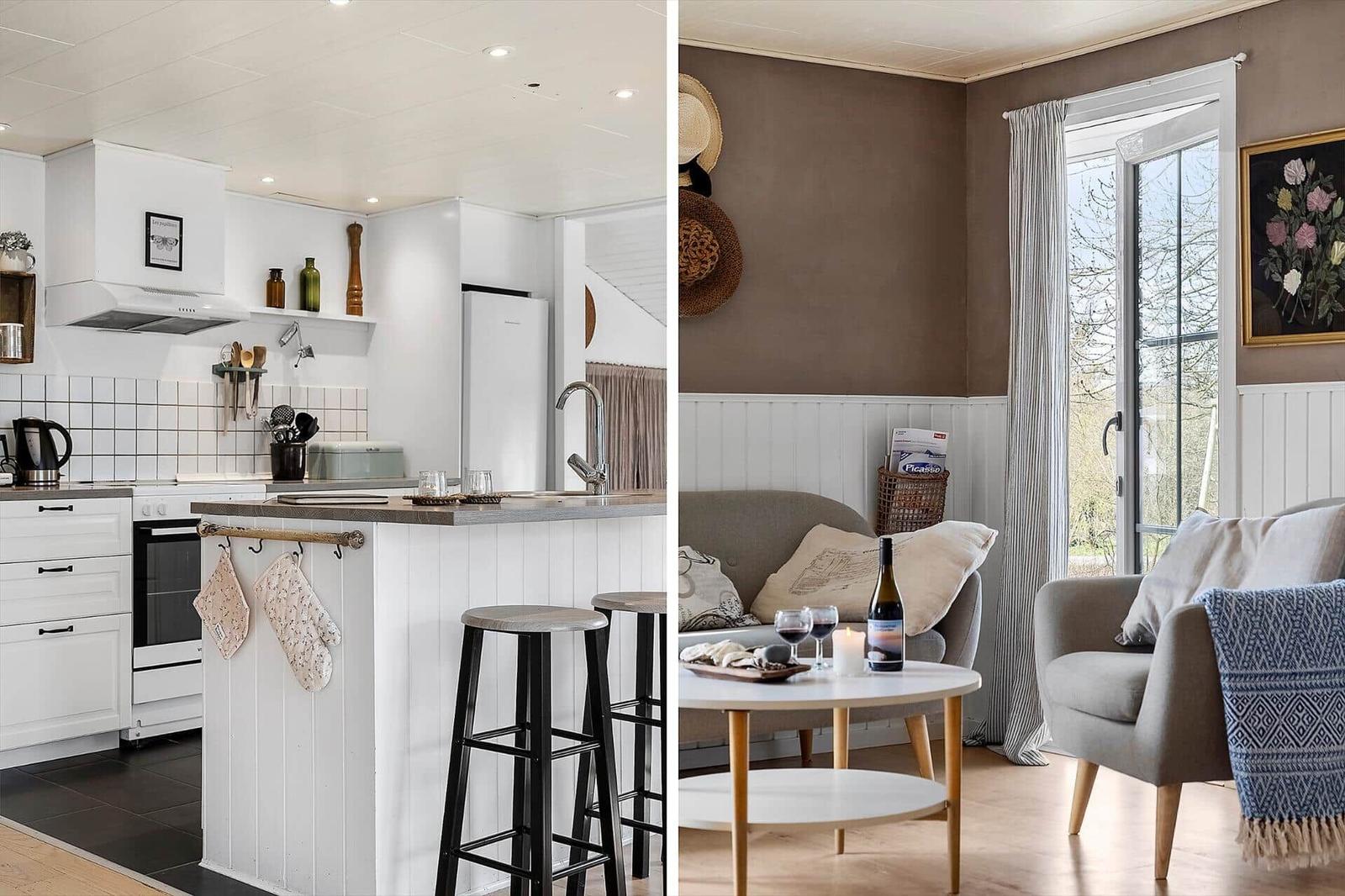 Küche mit weißen Schränken und Kücheninsel. Wohnzimmer mit Sofa, Tisch und Fenster.