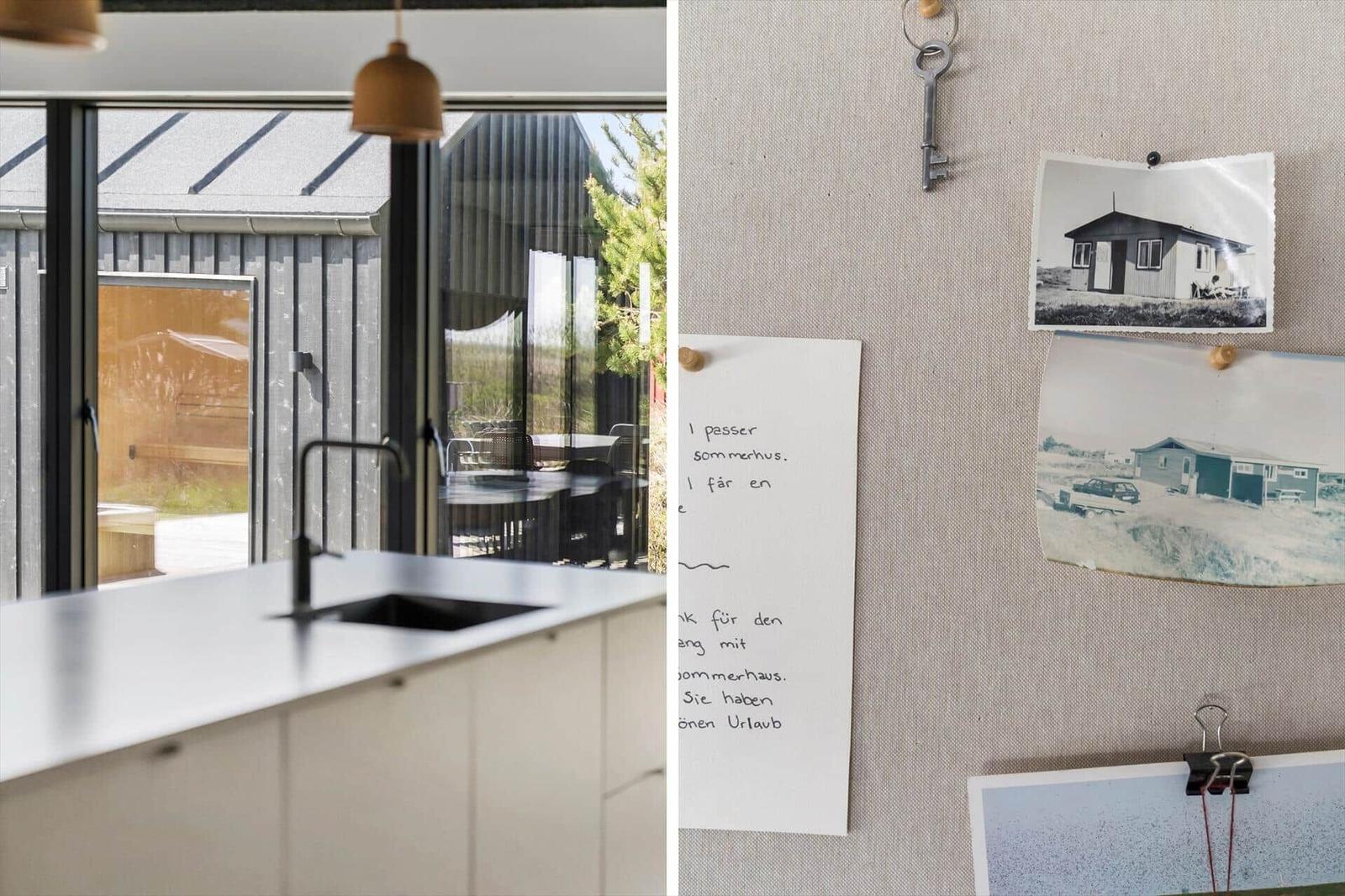 Küche mit Blick auf Terrasse und modernes Haus. Wand mit Fotos und Schlüssel.