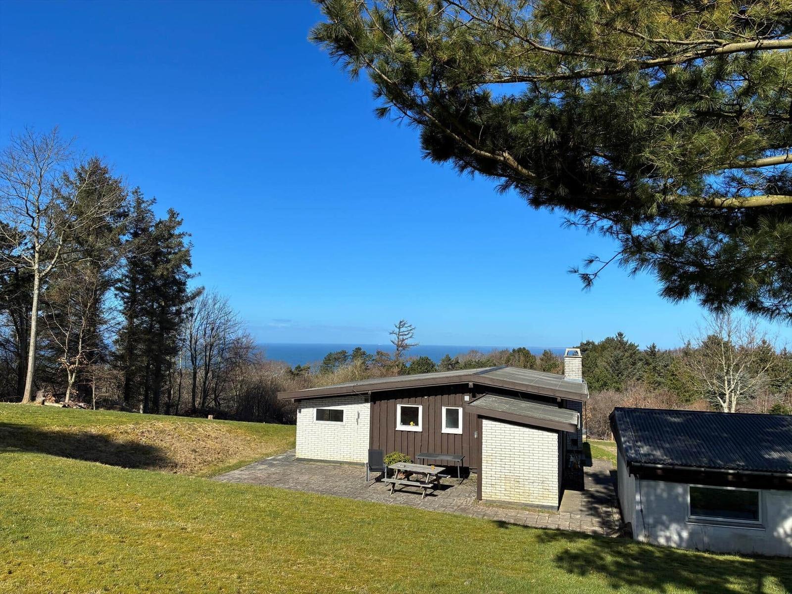Cabin with terrace and sea view under blue sky