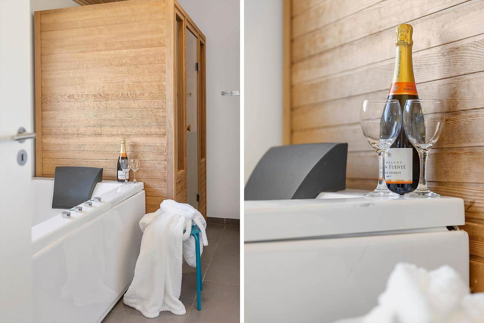 Badewanne mit Champagner und weißen Handtüchern vor Holzwand