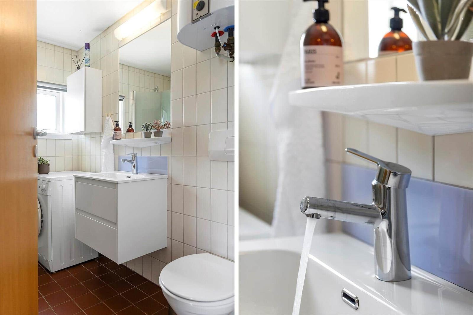 Badezimmer mit Waschmaschine, Spiegel und Toilette. Wasser fließt aus dem Wasserhahn.