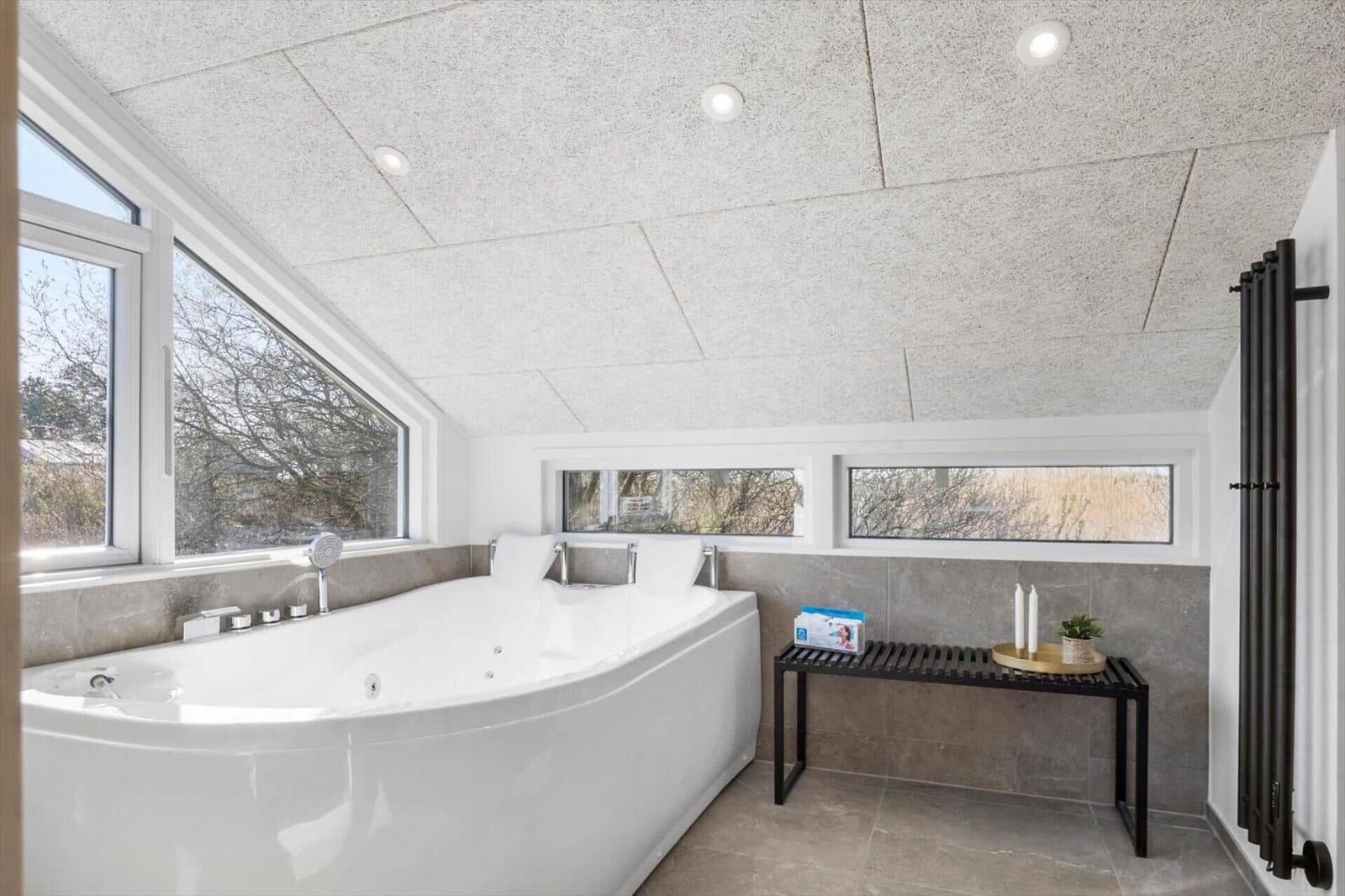 Bad mit Whirlpool, großem Fenster und moderner Ausstattung.