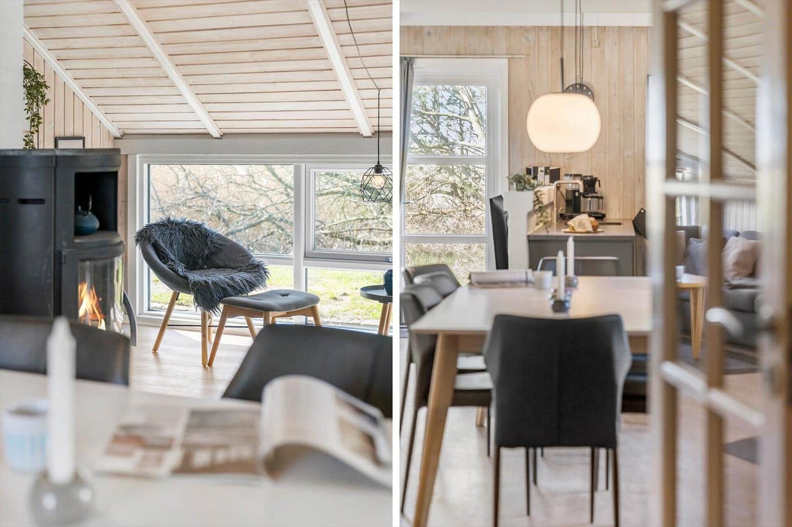Wohnbereich mit Kamin und Sitzgelegenheit. Essbereich mit Tisch und Stühlen. Holzwände und große Fenster.