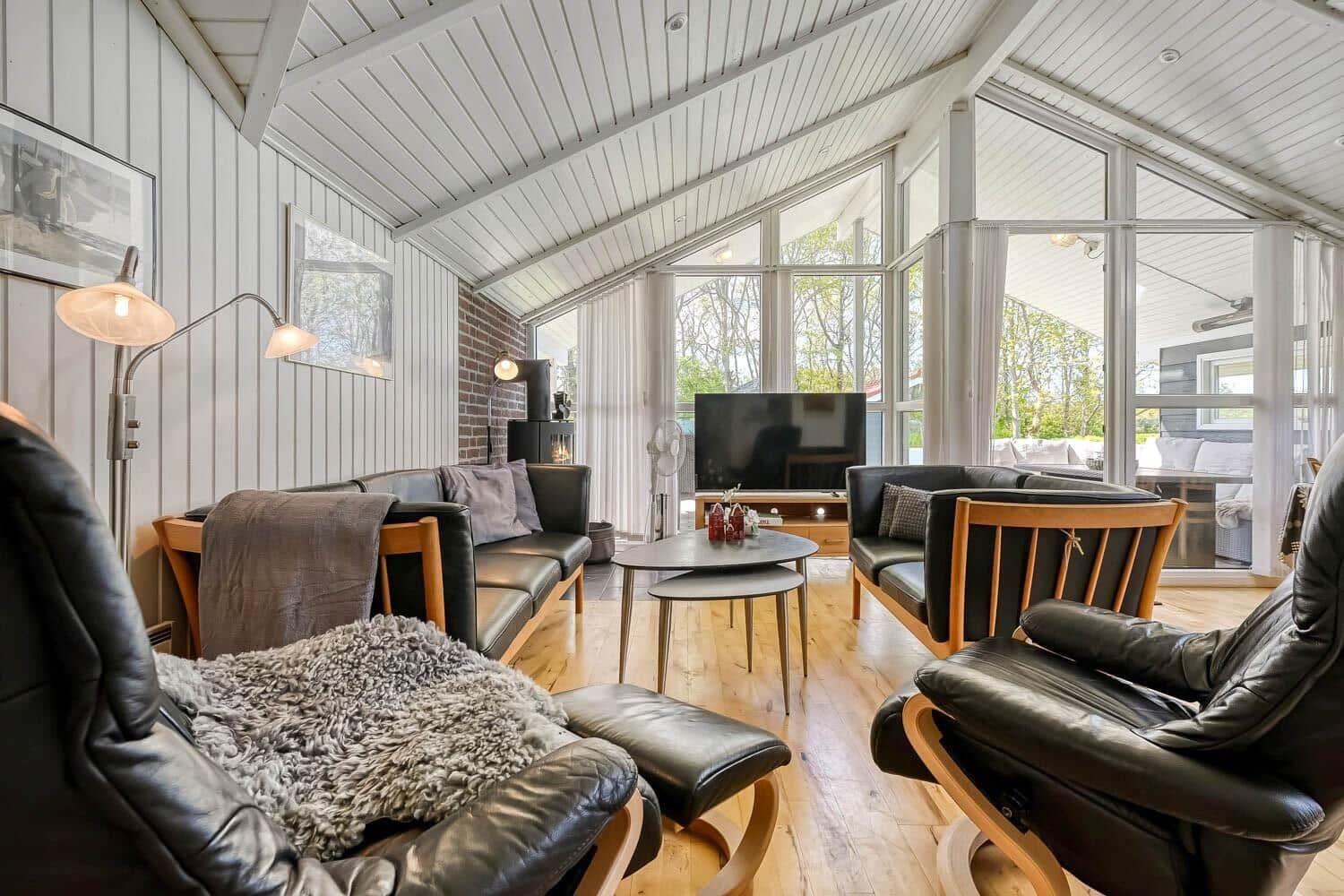 Living room with seating, TV, and large window area.