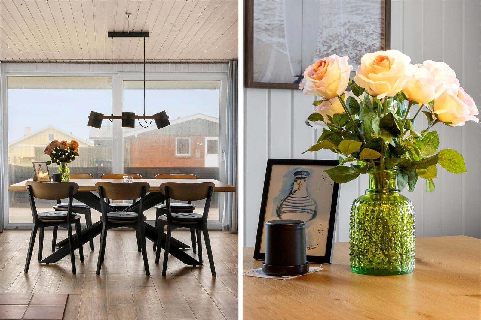 Dining area with table, chairs, and view to outside. Green vase with flower bouquet on table.