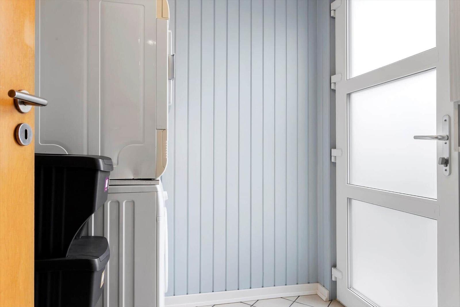 Entrance area with door, refrigerator, and heater.