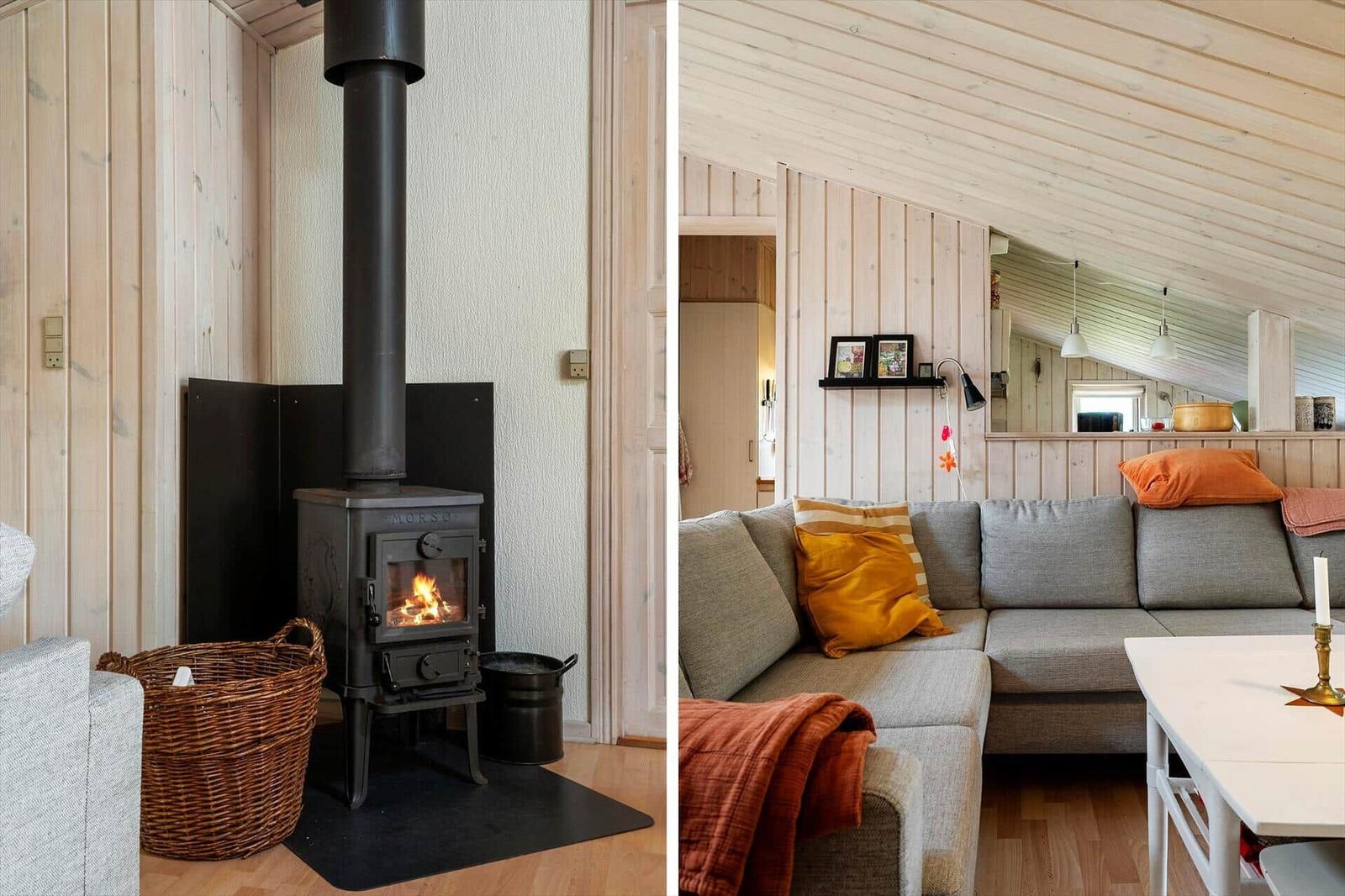 Kaminofen mit brennendem Feuer und Wohnzimmer mit Sofa und Tisch.