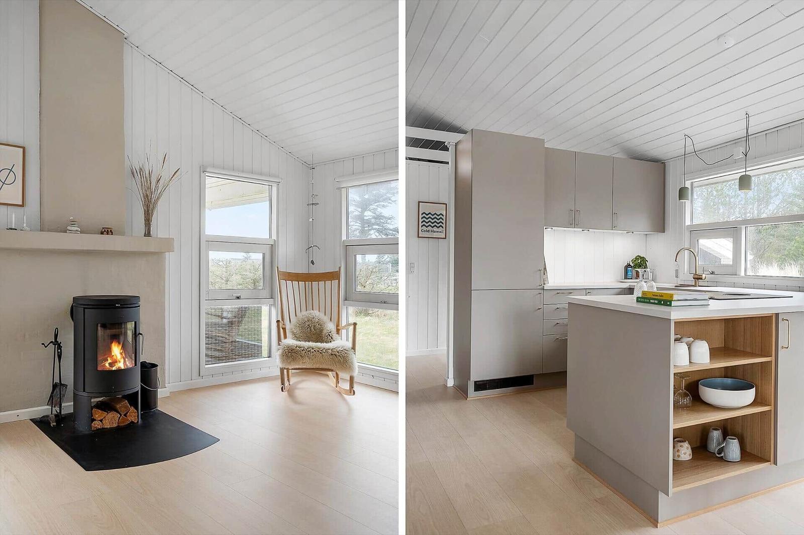 Wohnzimmer mit Kamin und Schaukelstuhl. Küche mit Kücheninsel und Fenster.