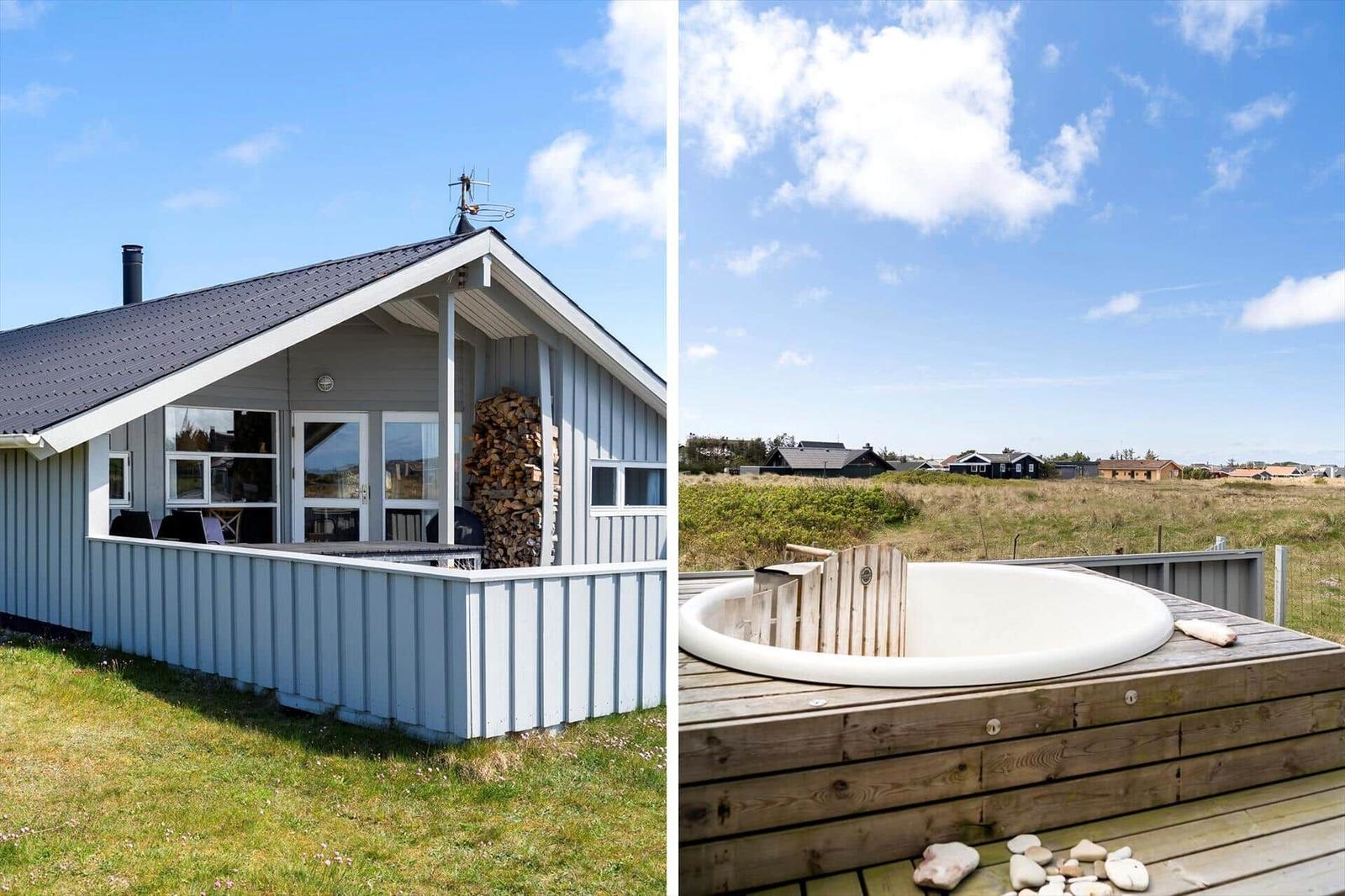 Haus mit Holzstapel und Dachterasse. Whirlpool auf Terrasse mit Blick auf Grasland.