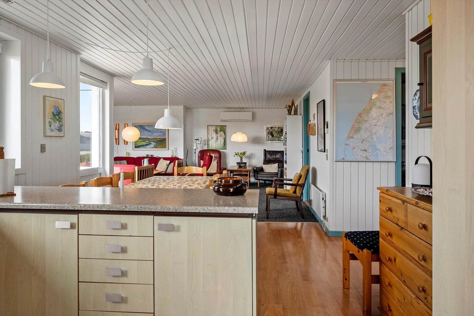 Kitchen with hardwood floor and dining area in the background.